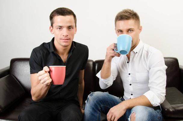 Two happy guys are drinking coffee. Business and education. - Photo, Image