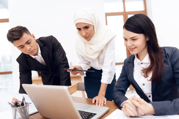 Arab woman in hijab working in office together with colleagues - Photo, Image