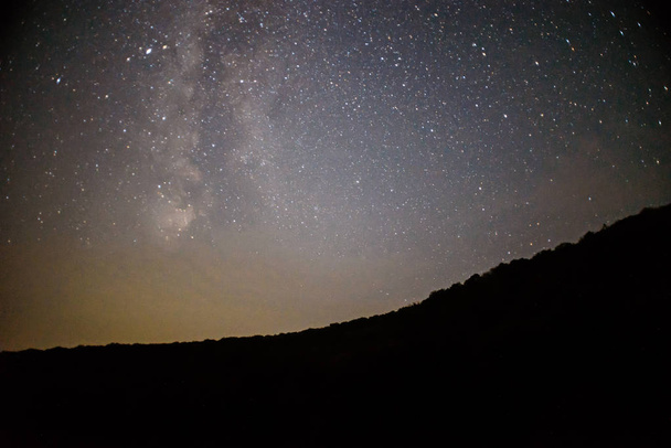 Bir gece açık gökyüzü bir tepe ve ön planda - Fotoğraf, Görsel