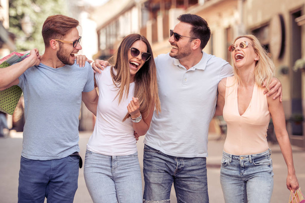 Four best friends enjoying after shopping.Shopping with friends is great. - Photo, image