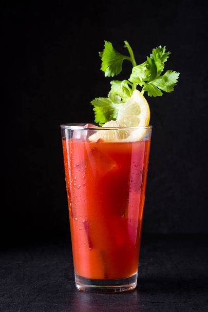 Bloody Mary cocktail in glass on black background. - 写真・画像