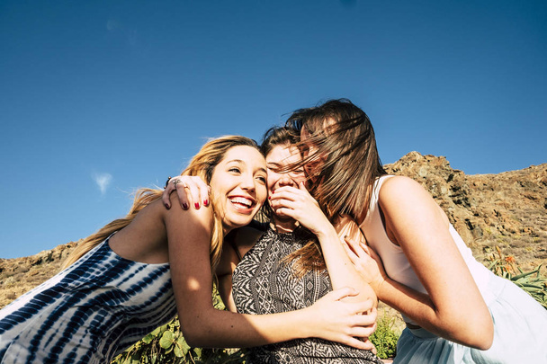 Eine Gruppe von 25-jährigen Mädchen umarmt und lacht gemeinsam in einem freundschaftlichen Teamwork. sonniger Urlaubstag oder freie Zeit für eine Gruppe. Schönheit Weibchen. - Foto, Bild
