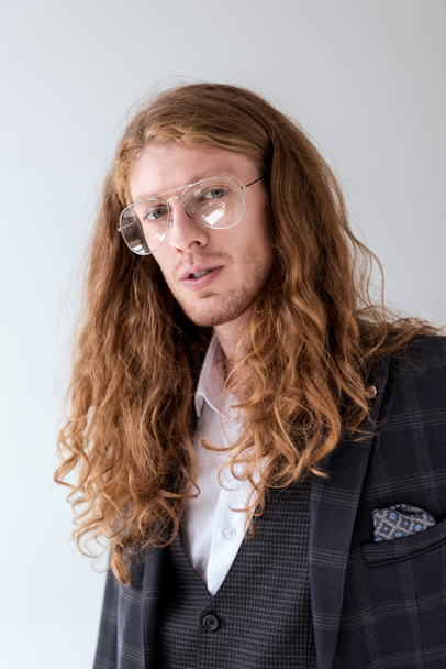 portrait of stylish businessman with curly hair looking at camera - Zdjęcie, obraz