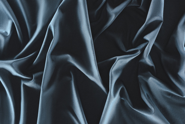 close up view of crumpled dark blue silk fabric as background - Fotoğraf, Görsel