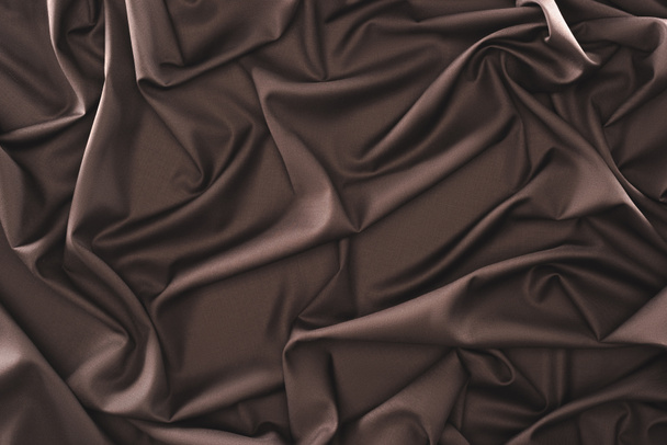 full frame of folded dark silk cloth as background - Photo, Image
