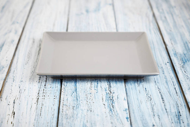 empty rectangular Plate on wooden table background - Zdjęcie, obraz