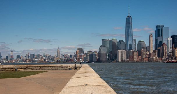 The skyline of New York City from the grounds of the Old Immigration Centre on Ellis Island - Photo, image