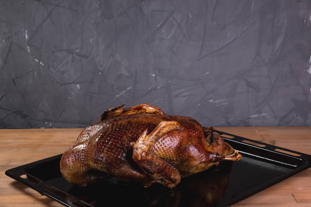 Beautiful food: baked whole duck close-up on a platter on the table. - 写真・画像