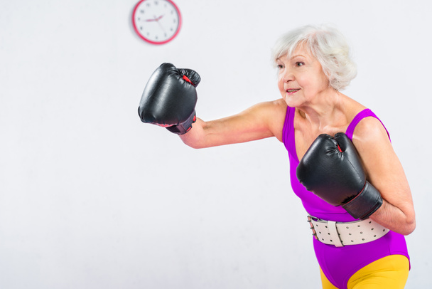 sportive senior lady boxing and looking away  - Fotoğraf, Görsel