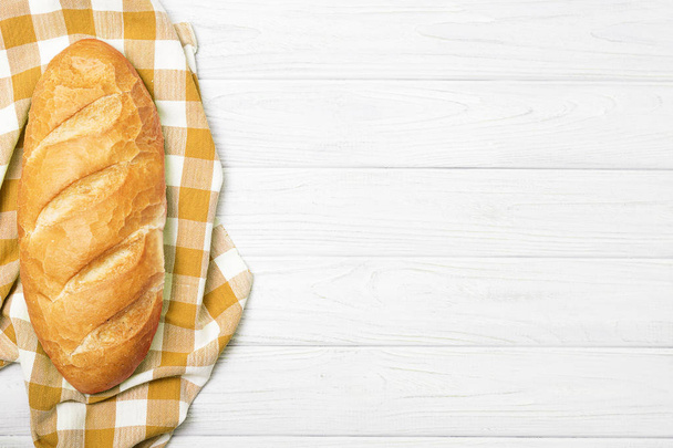 Fresh bread with napkin on kitchen table - Photo, Image