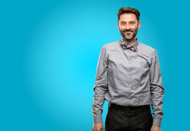 Middle age man, with beard and bow tie confident and happy with a big natural smile laughing - Photo, Image