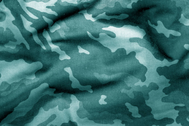 Military uniform pattern with blur effect in cyan tone. - Photo, Image