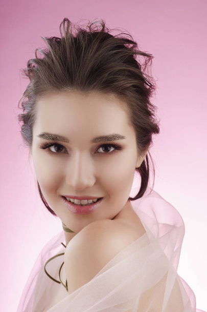 Closeup portrait of a beautiful smiling asian girl wearing pink  - Fotoğraf, Görsel