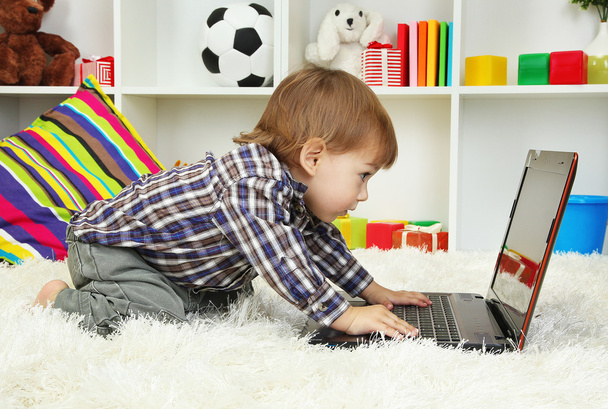 cute little boy and notebook in room - Foto, Imagem