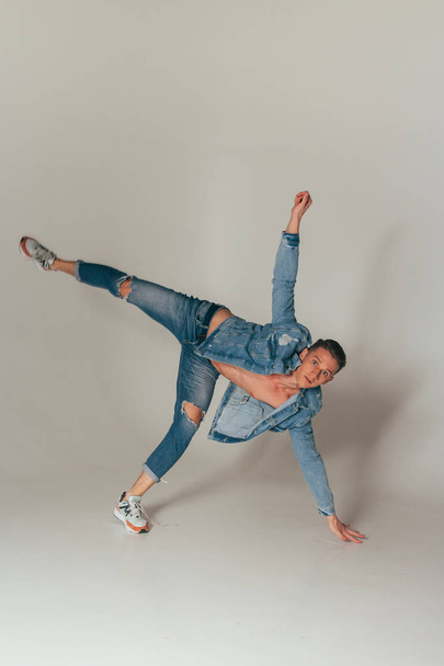 shot of jump feet up, of mad, crazy, cheerful, successful, lucky guy in casual outfit, jeans, jumping with hands up,triumphant, gesturing against white background - Фото, изображение