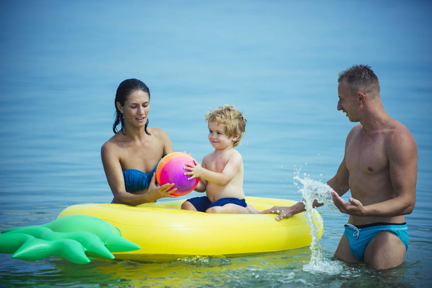 happy family have fun with air mattress at the beach. - Φωτογραφία, εικόνα