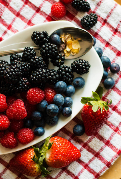 Macro view of blackberries, blueberries, raspberries and muesli - Valokuva, kuva