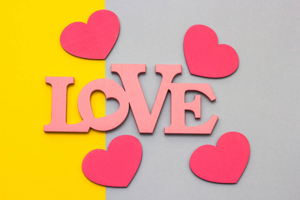 Wooden hearts on a multi-colored background, top view - Foto, immagini