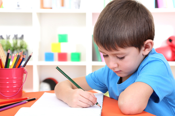 Cute little boy drawing in his album - Фото, изображение