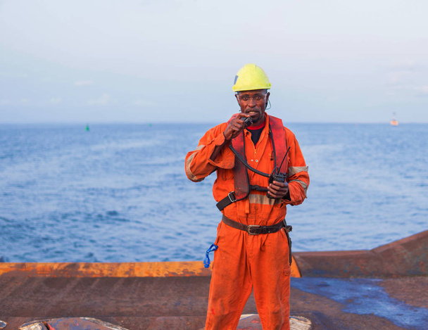Seaman AB or Bosun on deck of offshore vessel or ship , wearing PPE - Photo, Image