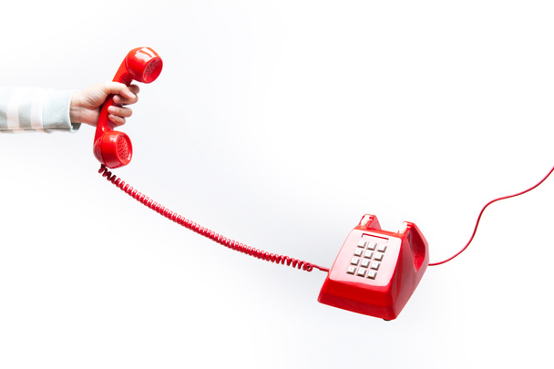 Класичний червоний телефонний приймач в руці
 - Фото, зображення
