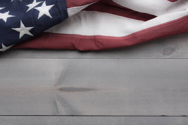 The flag of the United Sates on a grey plank background with copy space - 写真・画像