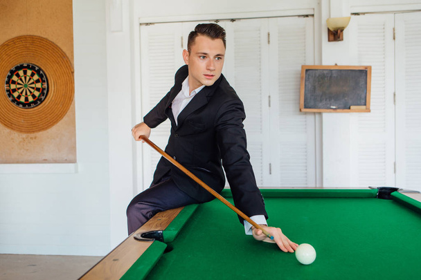 Young handsome man playing billiard game alone - Foto, Imagem