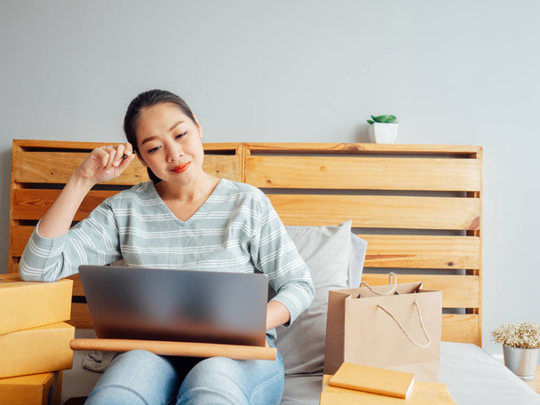Woman ready to ship the products of her online store to the cust - 写真・画像