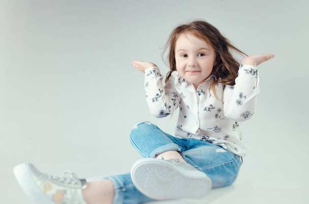 child in the Studio posing in fashionable clothes - Photo, Image
