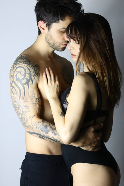 Side view of acctractive sensual couple on a white background - Foto, Bild