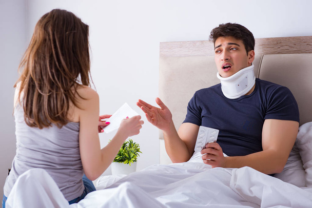 Loving wife taking care of injured husband in bed - Photo, image