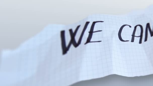 Wort "wir können" auf zerrissenem Papier auf Gradientenhintergrund - Filmmaterial, Video