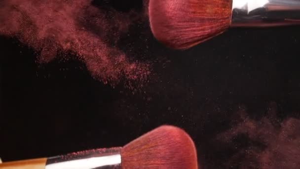Make-up brush with pink powder on black background - Filmagem, Vídeo
