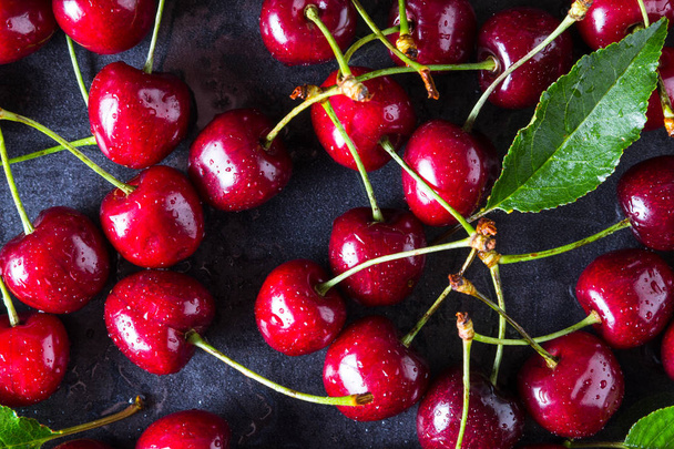 Fresh red ripe cherries on dark grey table - Photo, Image