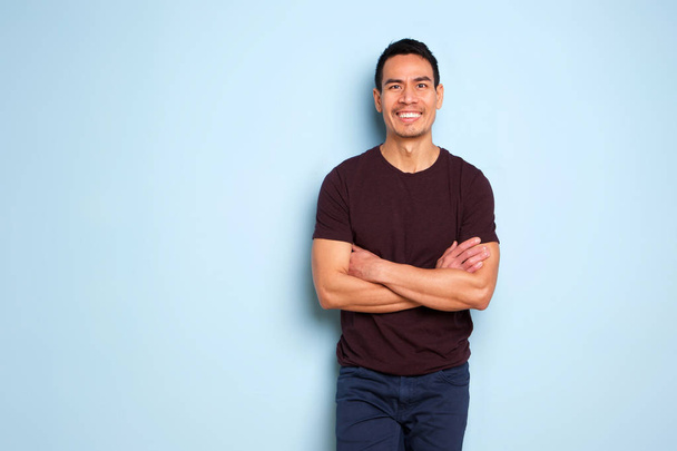 Portrait of good looking asian guy in stylish outfit posing over blue background - Photo, Image