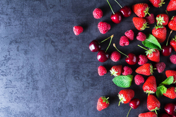 Fresh red ripe berries on dark grey table - Valokuva, kuva