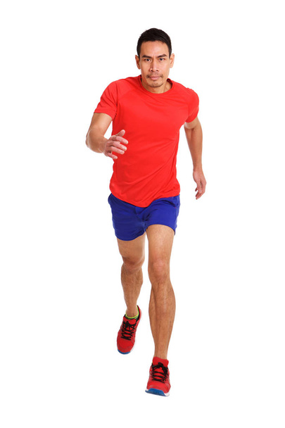 Full length portrait of healthy middle aged asian man running over white background - Photo, Image