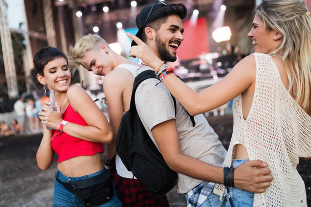Happy young friends having fun at music festival - Foto, imagen