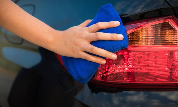 Close up portrait of woman hand cleaning a car - Foto, Imagen