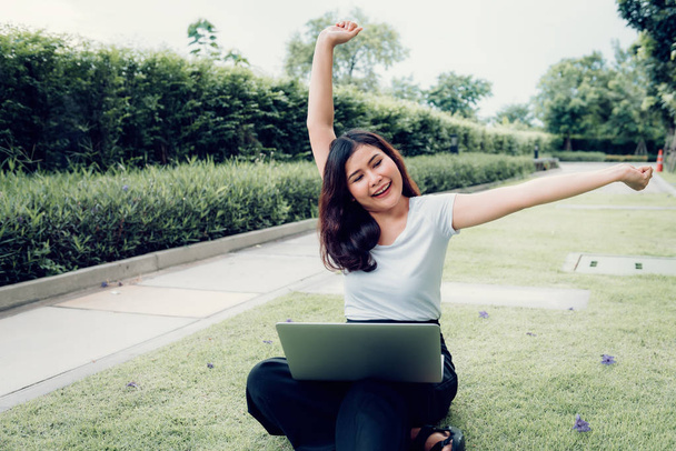 Portrait of asian woman relaxing outdoor with her laptop  - Zdjęcie, obraz