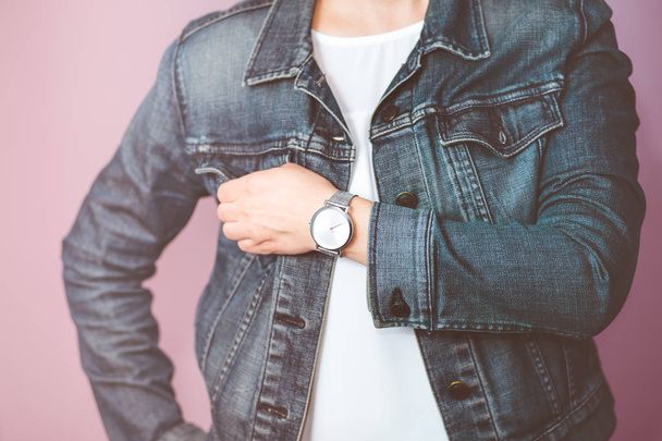 Woman wearing silver wristwatch and jeans jacket - 写真・画像