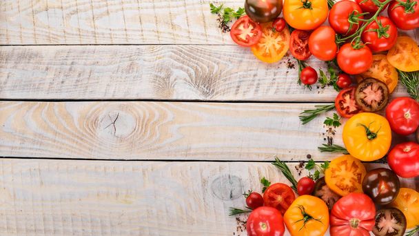 Colored tomatoes On a white wooden background. Top view. Copy space. - Photo, image