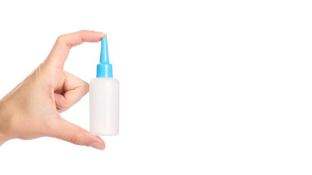 White glue container in hand isolated on a white background. copy space, template - Foto, immagini