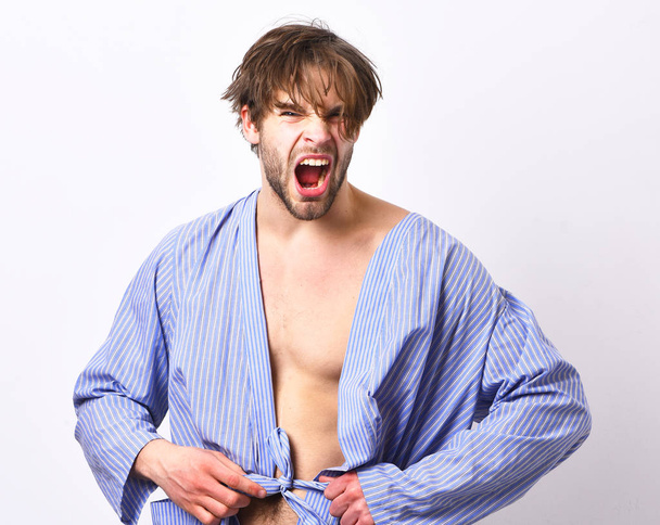 Sexy macho with angry face stands in bathrobe. Morning concept. - Fotoğraf, Görsel
