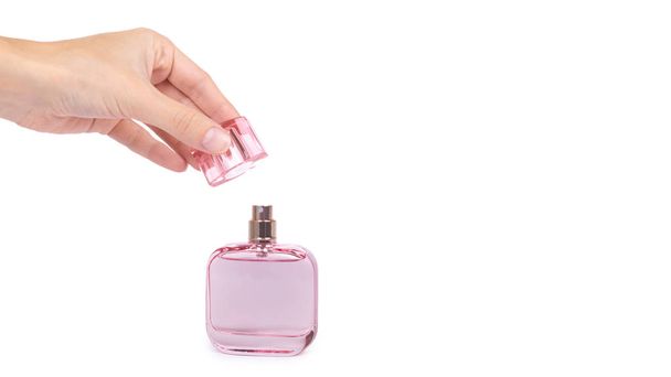 women's perfume in beautiful pink bottle isolated on white background, luxury smell, crystall glass. copy space, template - Photo, Image