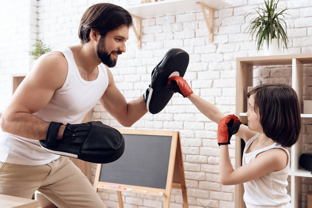 Athletic bearded father teaches son to box. - Valokuva, kuva