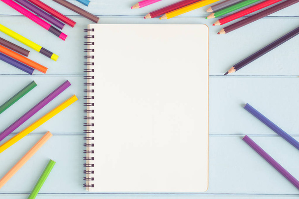 Blank notebook with colorful pencil on blue wooden table,top vie - Foto, Imagem