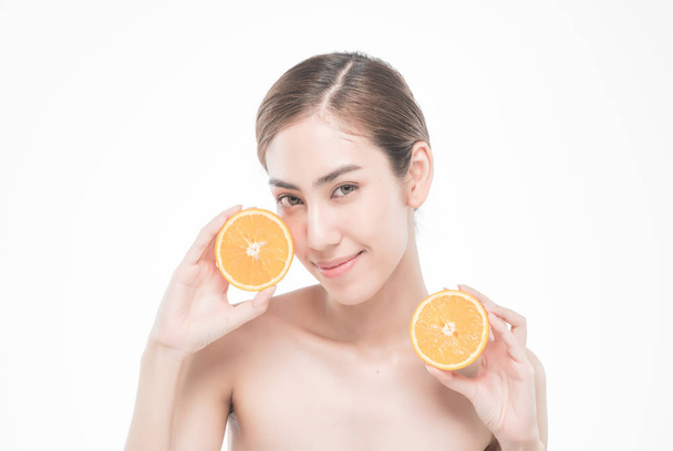  young woman holding juicy oranges before her face . Healthy eating concept. Diet. Isolated over white. - Foto, Imagem