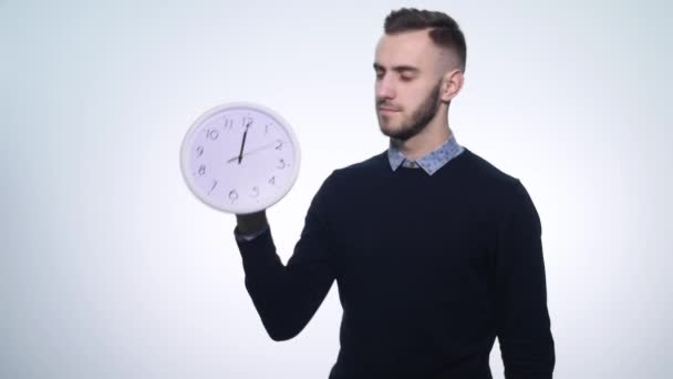 Man holding clock on isolated white background - Filmmaterial, Video