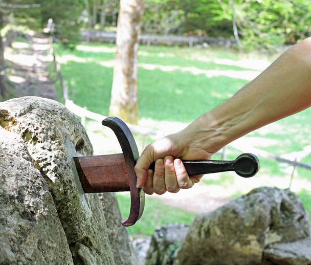 Hand and the Excalibur sword in the stone - Photo, Image